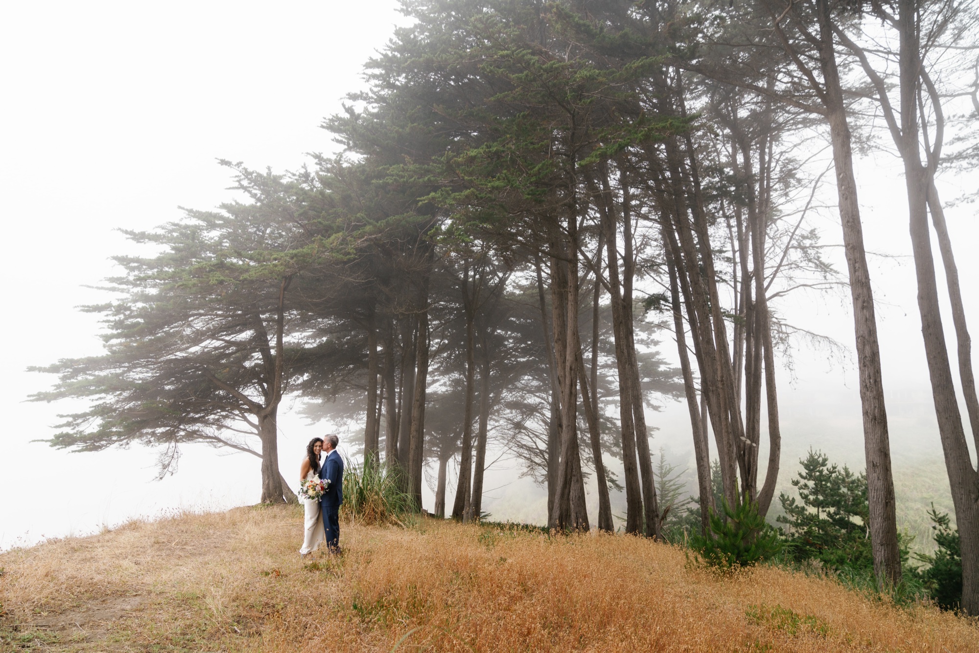 wedding portraits on the cliffs of Aptos Beach with cypress trees