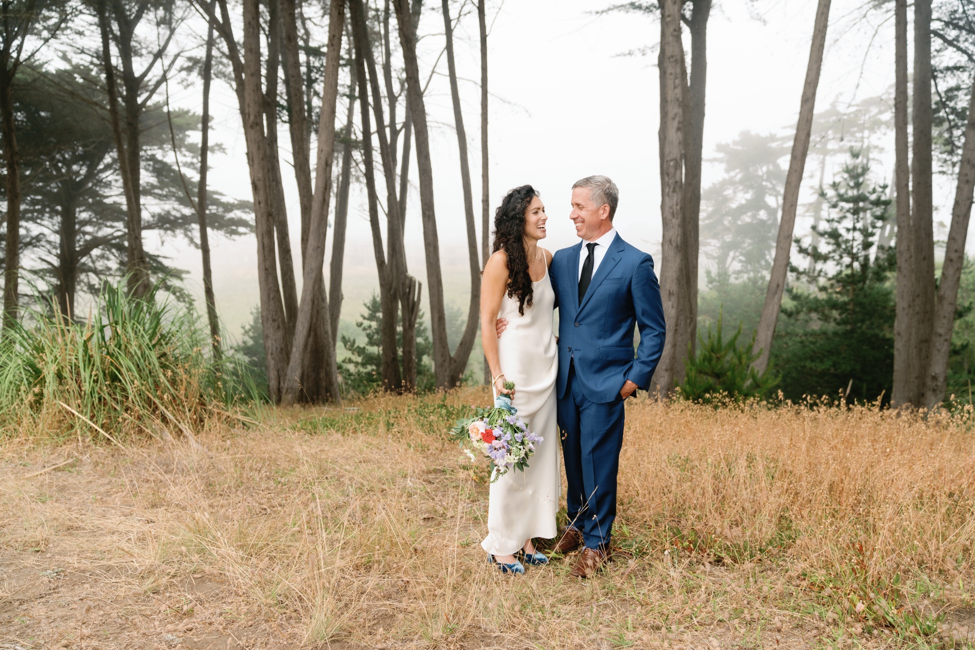 wedding portraits on the cliffs of Aptos Beach with cypress trees