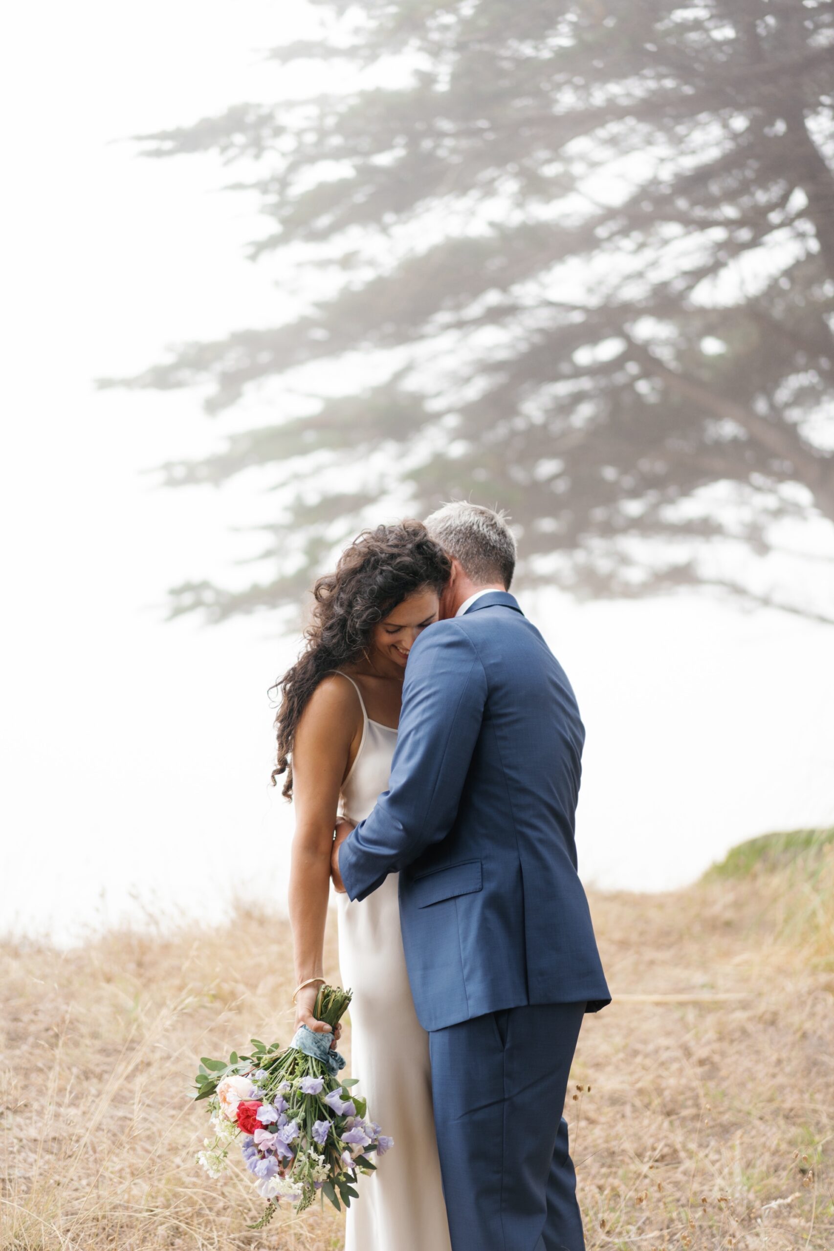 wedding portraits on the cliffs of Aptos Beach with cypress trees