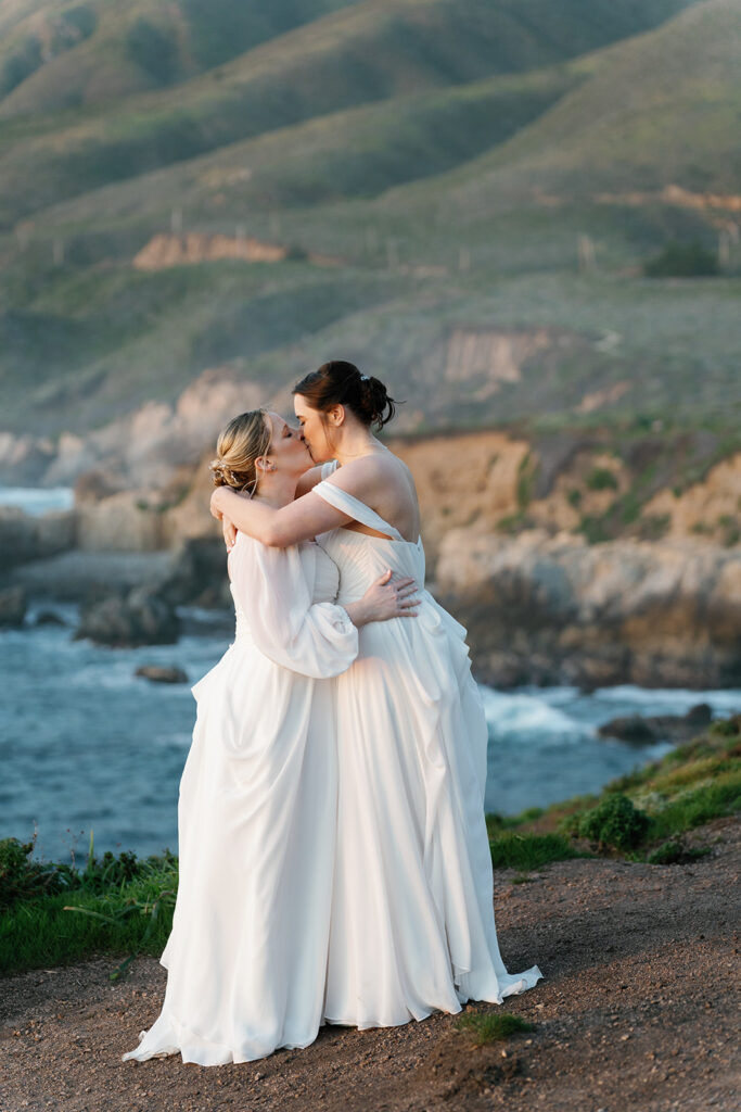 LGBTQ Wedding in Big Sur Brides kissing each other on the ocean bluffs